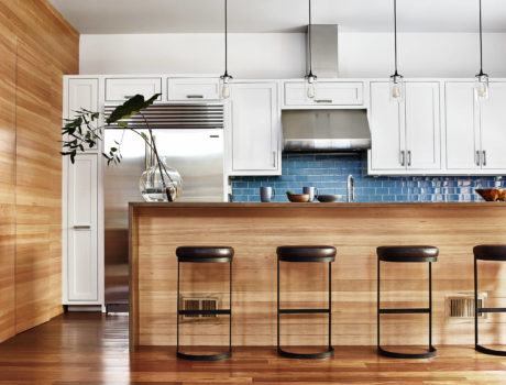 Contemporary kitchen with blue tile backsplash and wooden accents.