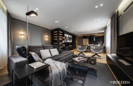 Chic living room with monochrome palette, sleek furniture, and ambient lighting.