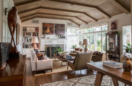 Elegant living room with exposed beams and fireplace.