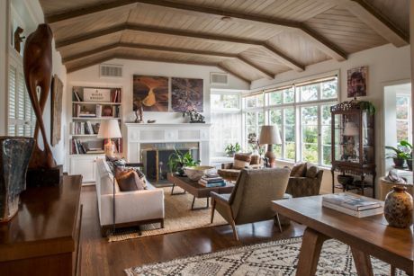 Elegant living room with exposed beams and fireplace.