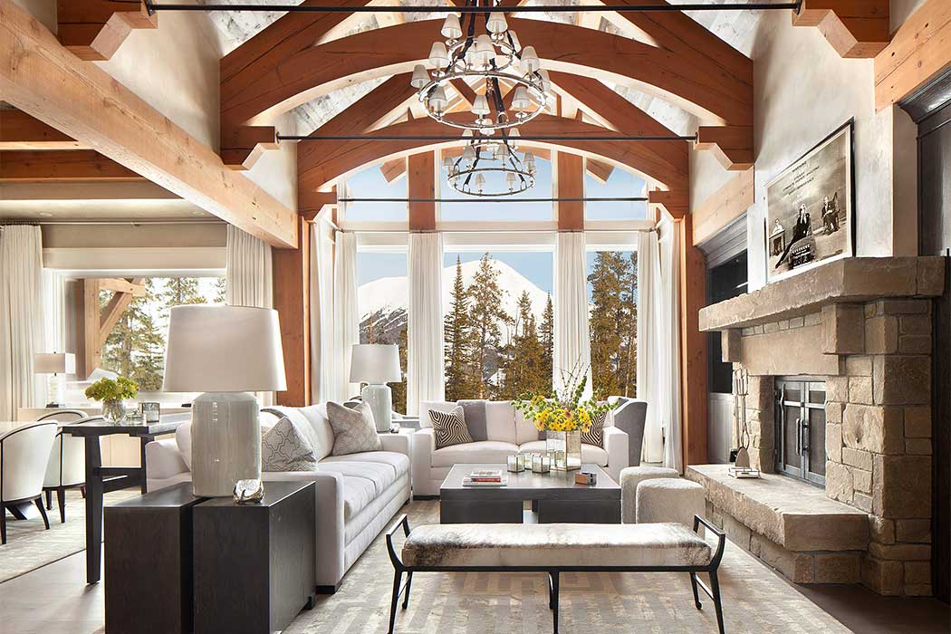 Rustic-chic living room with exposed beams and large windows.