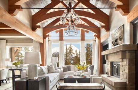 Rustic-chic living room with exposed beams and large windows.