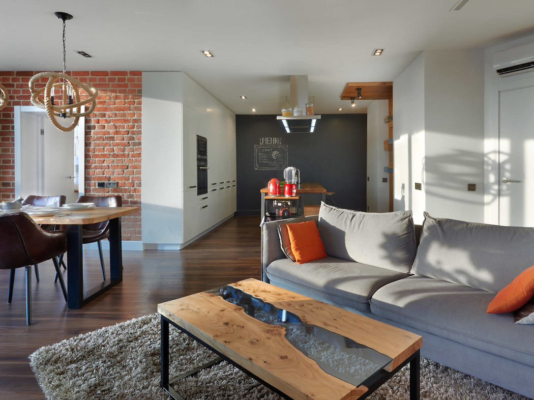 Stylish living space with exposed brick, contemporary furnishings, and a chalkboard