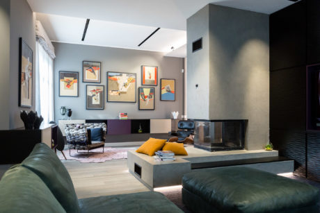 Modern living room with fireplace and art on walls.