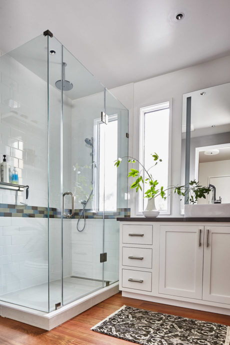 Sleek bathroom with glass shower and white vanity.
