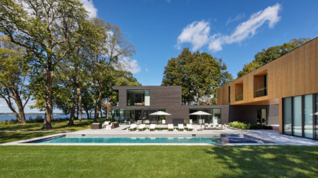 Contemporary house with pool and outdoor dining area.