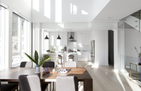 Bright, airy dining and kitchen space with high ceilings and sleek design.