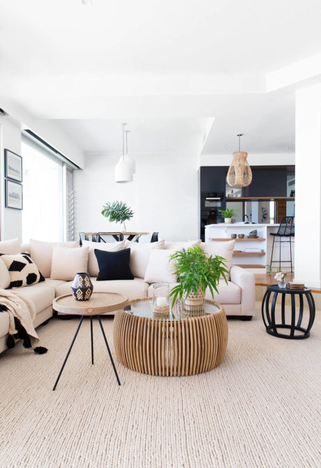 Contemporary living room with neutral tones and pendant lighting.