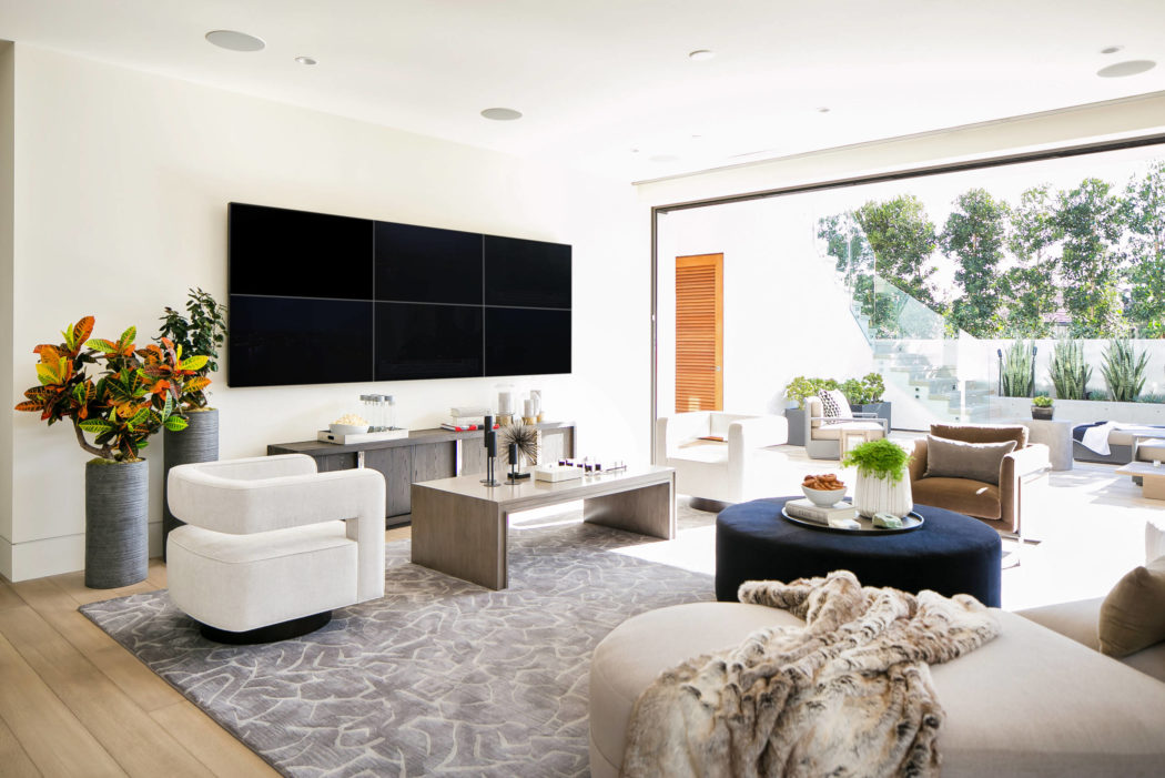 Contemporary living room with sleek furnishings and sliding glass doors.