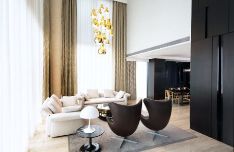 Minimalist living room with chic furniture and golden chandelier.