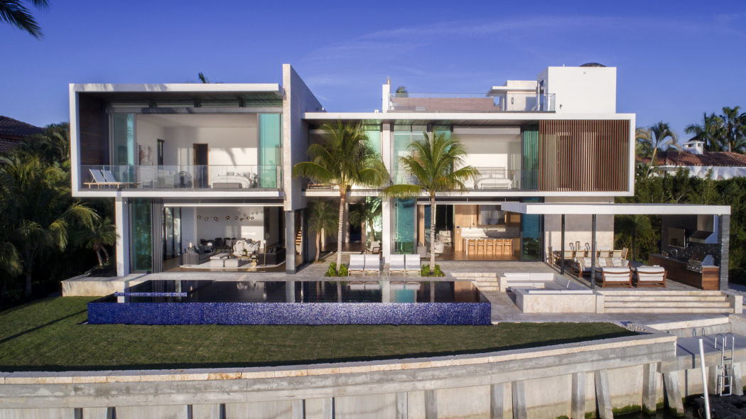 Contemporary luxury villa with pool and glass facades.
