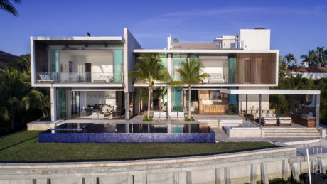 Contemporary luxury villa with pool and glass facades.