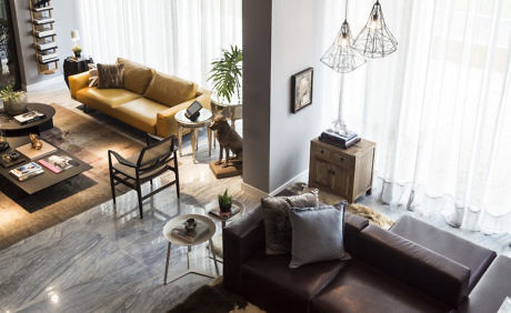 Modern living room with two sofas and stylish lighting.