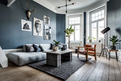 Elegant living room with gray walls, modern furniture, and artworks.