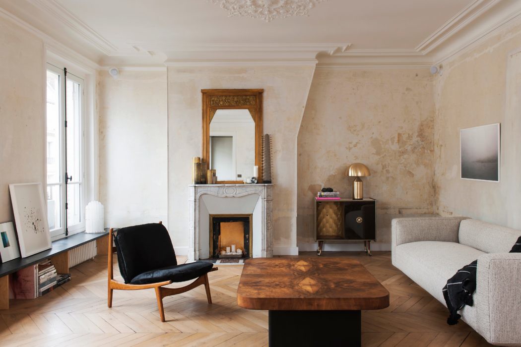 Elegant living room with fireplace, herringbone floor, and modern furniture.