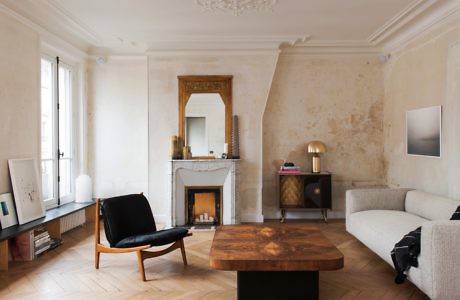 Elegant living room with fireplace, herringbone floor, and modern furniture.