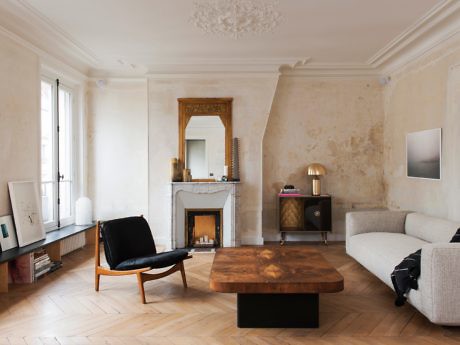 Elegant living room with fireplace, herringbone floor, and modern furniture.