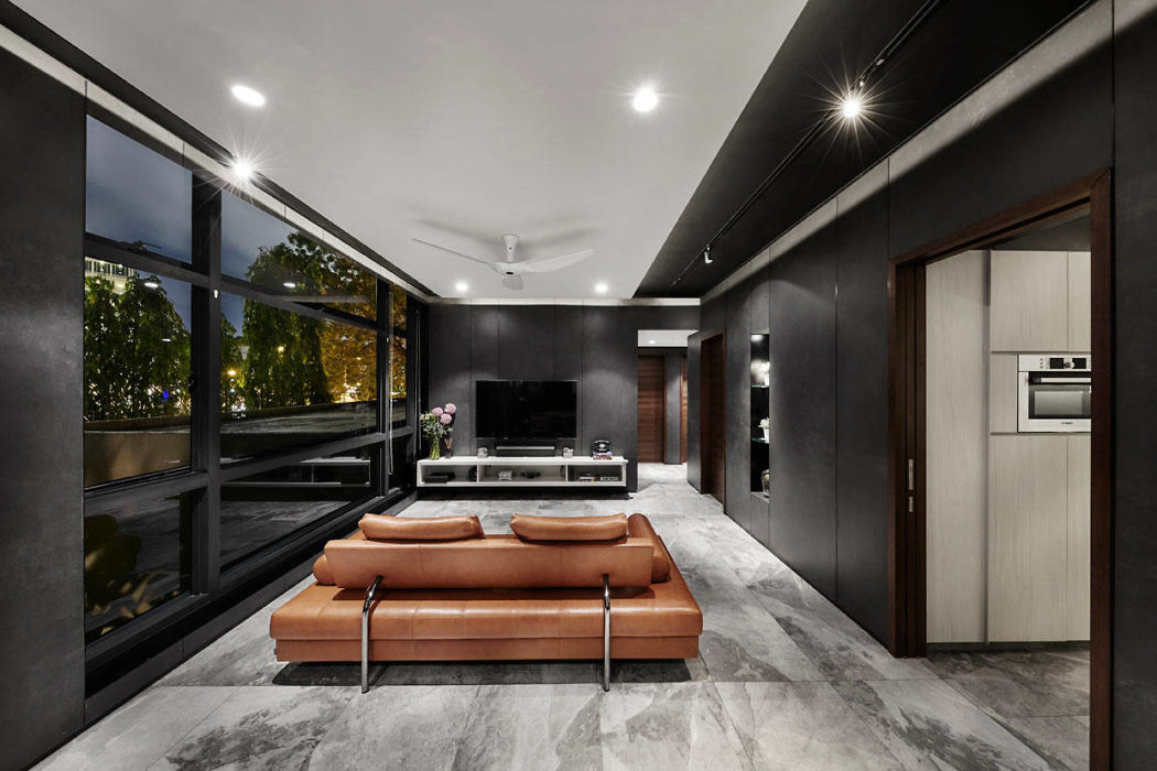 Contemporary living room with sleek design and tan leather couch.