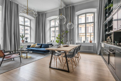 Elegant dining room with high ceilings and large windows.