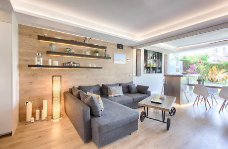 Contemporary living room with wood paneling and sectional sofa.