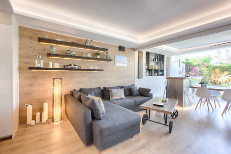 Contemporary living room with wood paneling and sectional sofa.