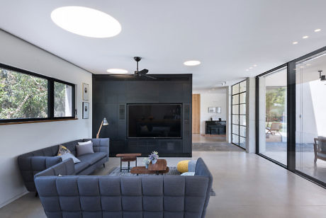 Contemporary living room with sleek furnishings and large sliding glass doors.