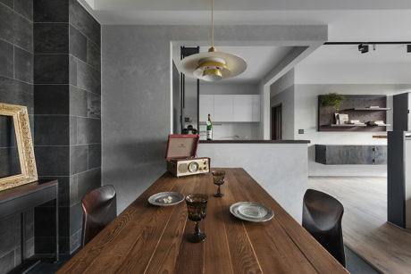 Sleek kitchen interior with wooden table and retro accents.