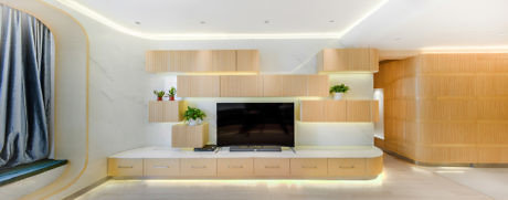 Modern living room interior with wooden shelving and mounted TV.