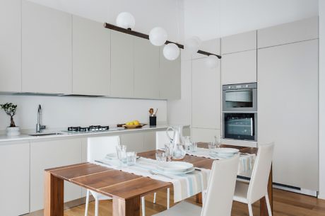 Modern kitchen with dining table set for a meal.