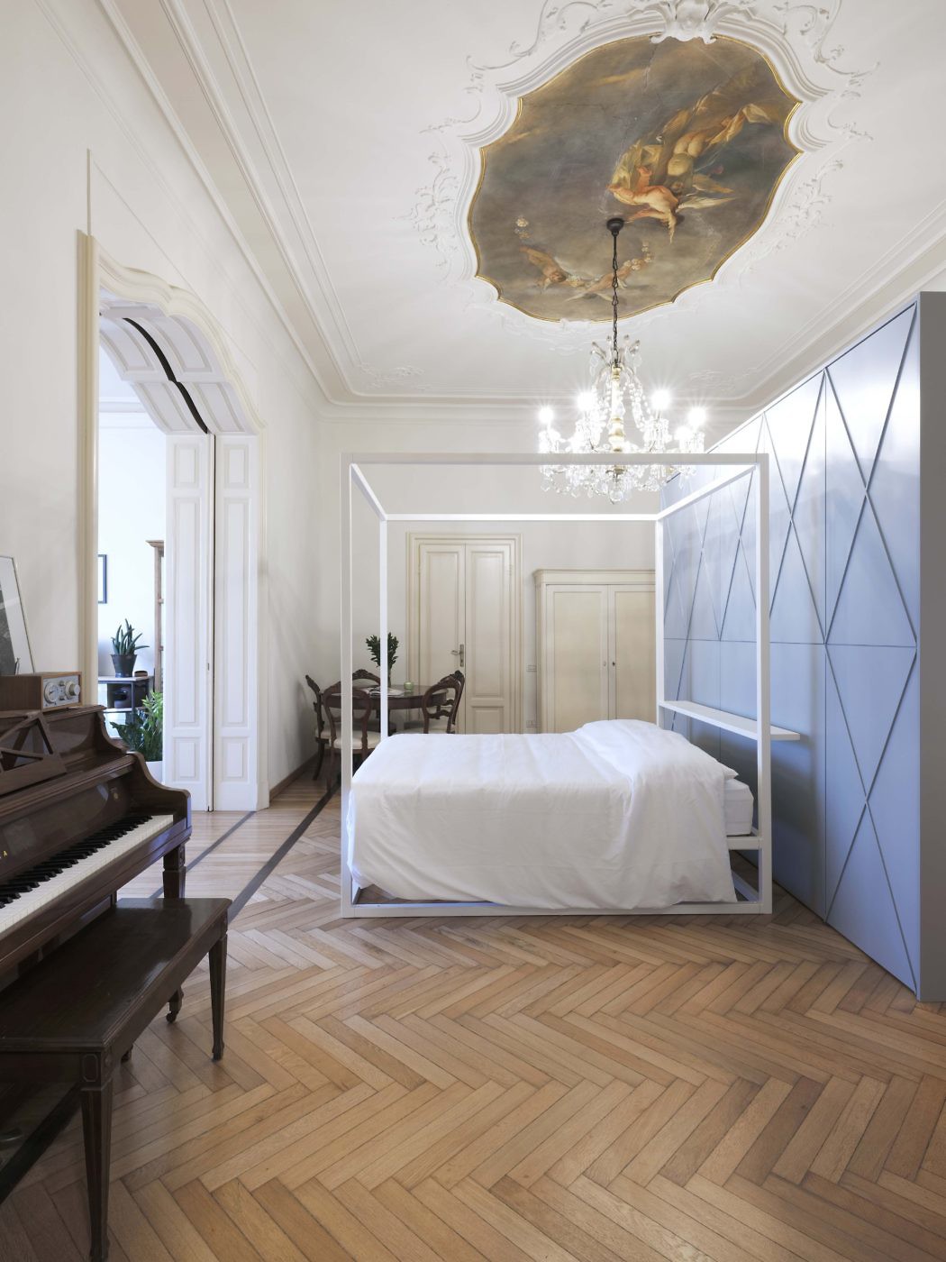 Elegant room with classic ceiling fresco and a juxtaposition of contemporary geometric closet