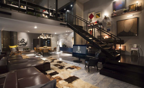 Chic loft space with an open plan, sleek staircase, and eclectic decor.