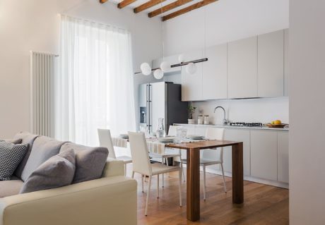 Minimalist living space with exposed wooden beams and neutral tones.