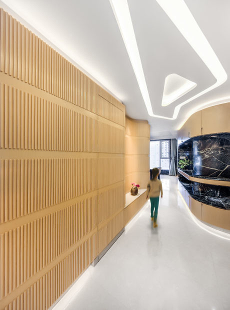 Contemporary hallway with sculptural lighting and textured walls.