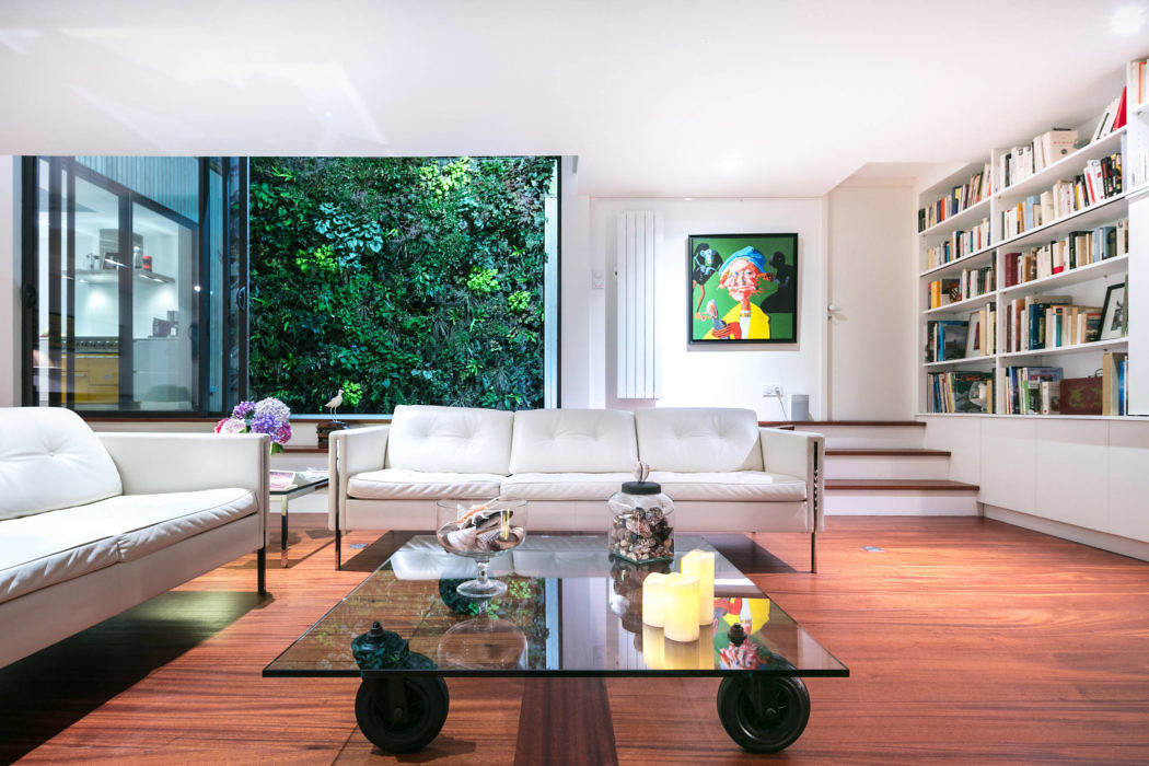 Sleek living room with large bookshelf and floor-to-ceiling windows.