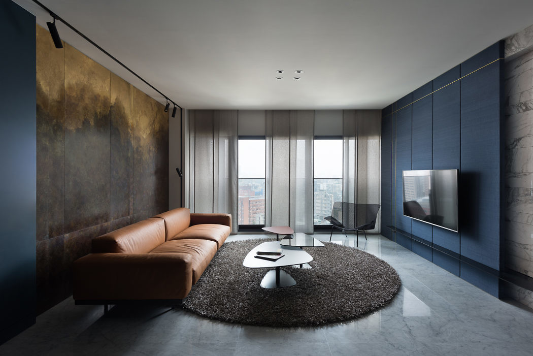 Contemporary living room with a leather sofa, circular rug, and city view.