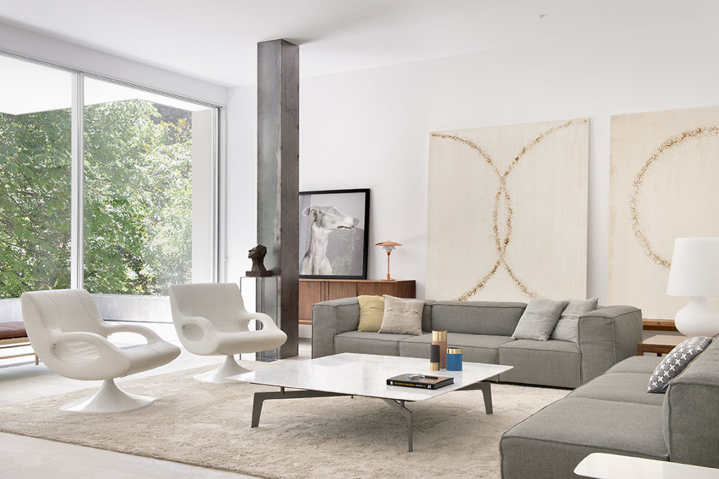 Contemporary living room with minimalist decor and natural light.