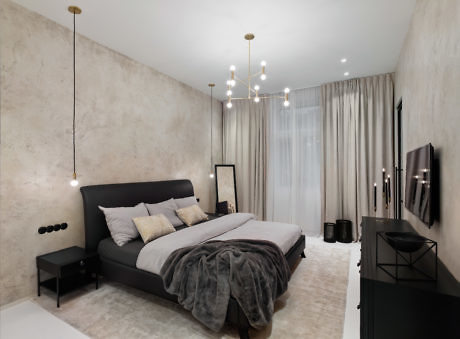 Minimalist bedroom with concrete walls and chic pendant lights.