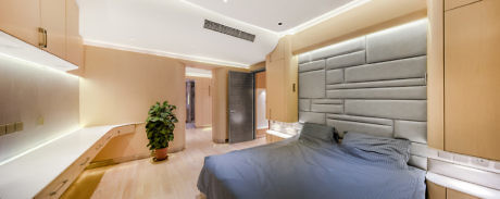 Contemporary bedroom with padded headboard and warm lighting.
