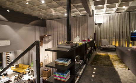 Contemporary loft with open layout, mezzanine bedroom, and industrial accents.