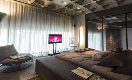 Contemporary living room with large sectional and sheer curtains