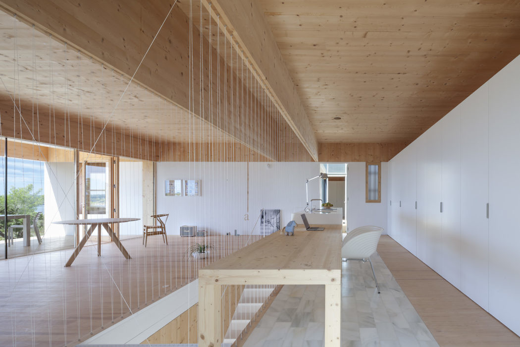 Contemporary wooden interior with a long table, clean lines, and ample natural light