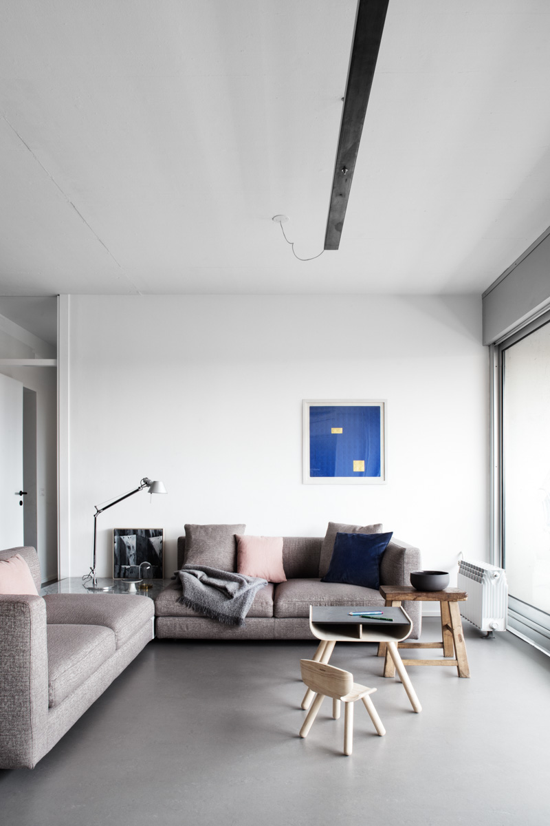 Minimalist living room with neutral tones and sleek furnishings.