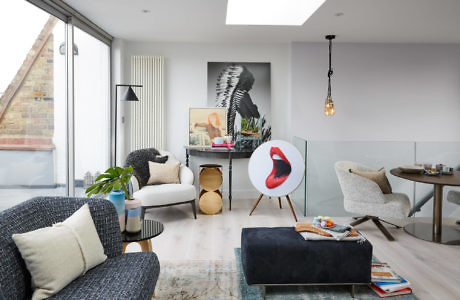 Contemporary living room with eclectic decor and large window.