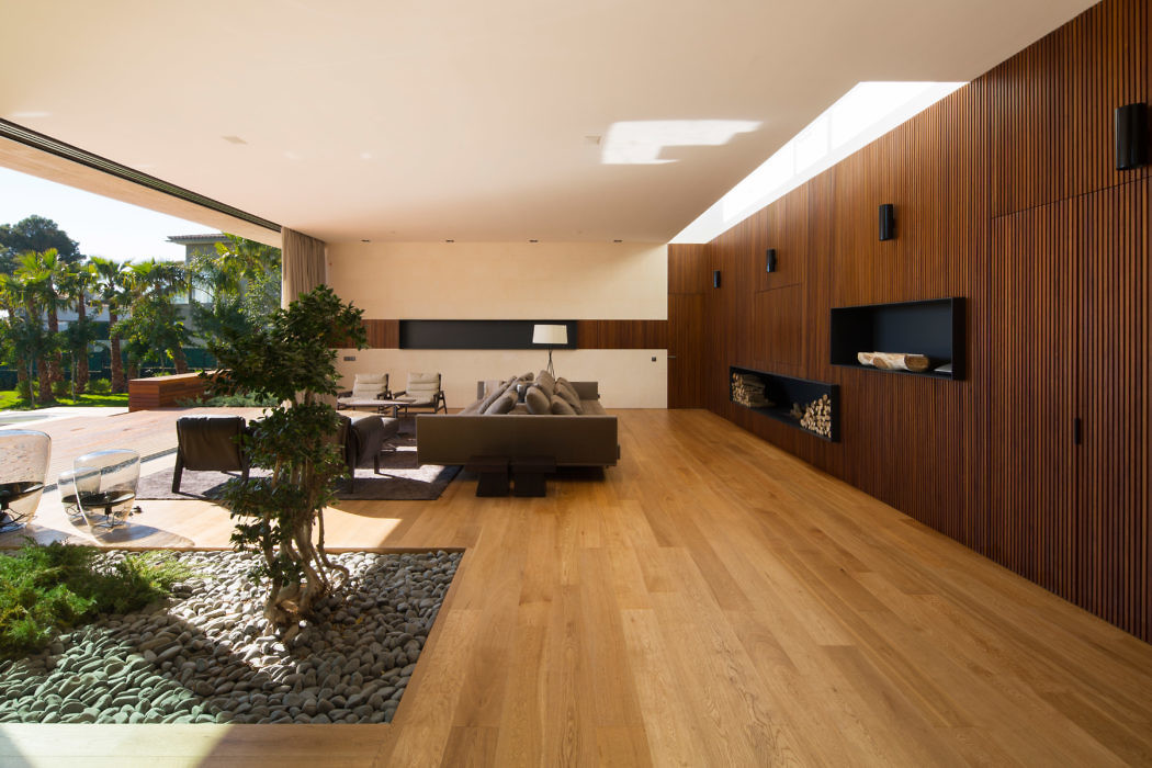 Contemporary living space with sleek wooden design and indoor garden.