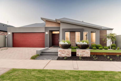 Modern single-story house with red garage door and landscaped front yard.