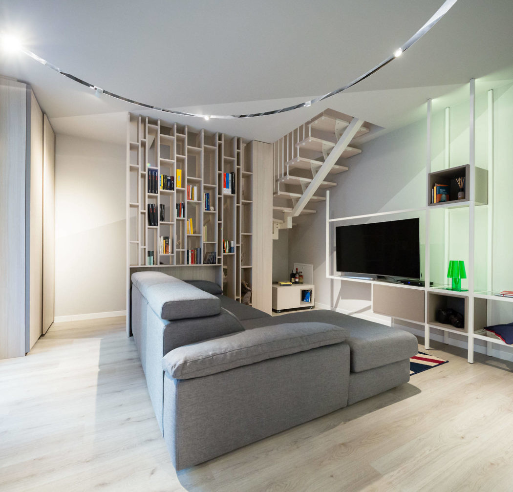 Sleek living room with curved bookshelf, L-shaped sofa, and a
