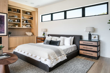 Contemporary bedroom with horizontal window and wooden shelving.