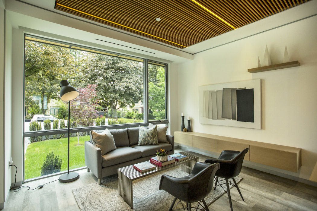 Modern living room with large window overlooking a garden.