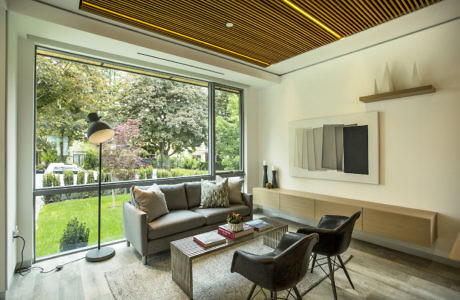 Modern living room with large window overlooking a garden.