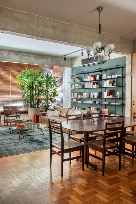 Industrial-chic dining room with exposed concrete and wooden furnishings.